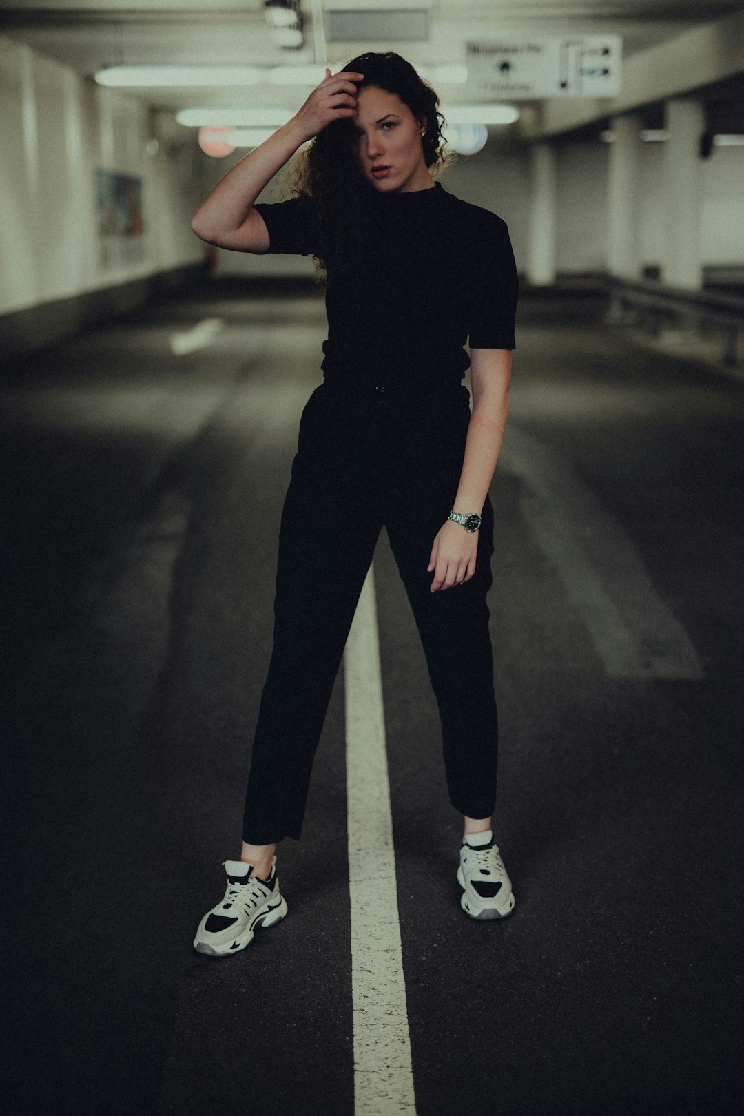 woman in black shirt and pants wearing white nike sneakers