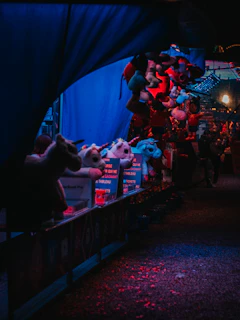 A haunted carnival ticket booth with flickering lanterns and cobwebs.