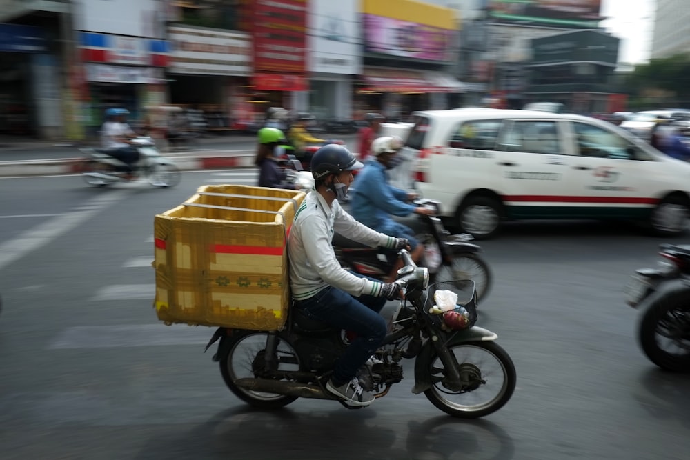 man in white long sleeve shirt riding motorcycle on road during daytime