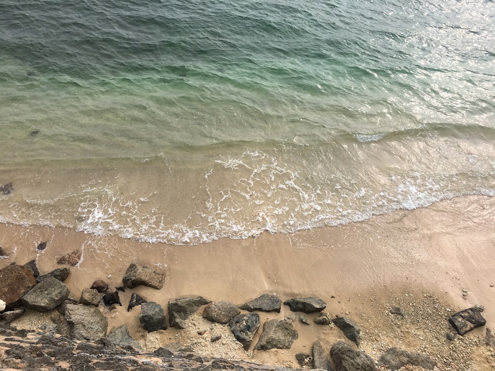 brown rocks on seashore during daytime