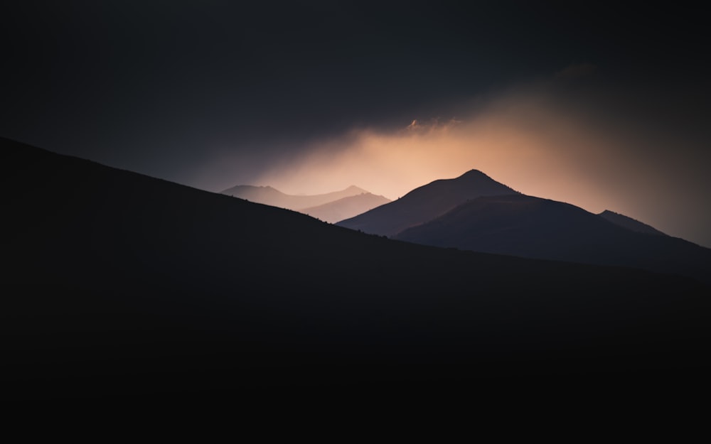 silhouette of mountains during sunset