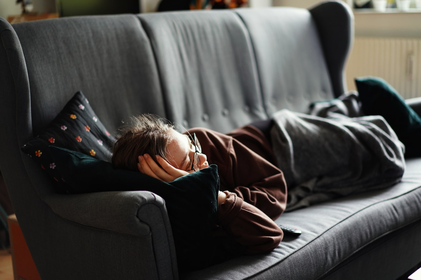 A person relaxing or asleep on a sofa