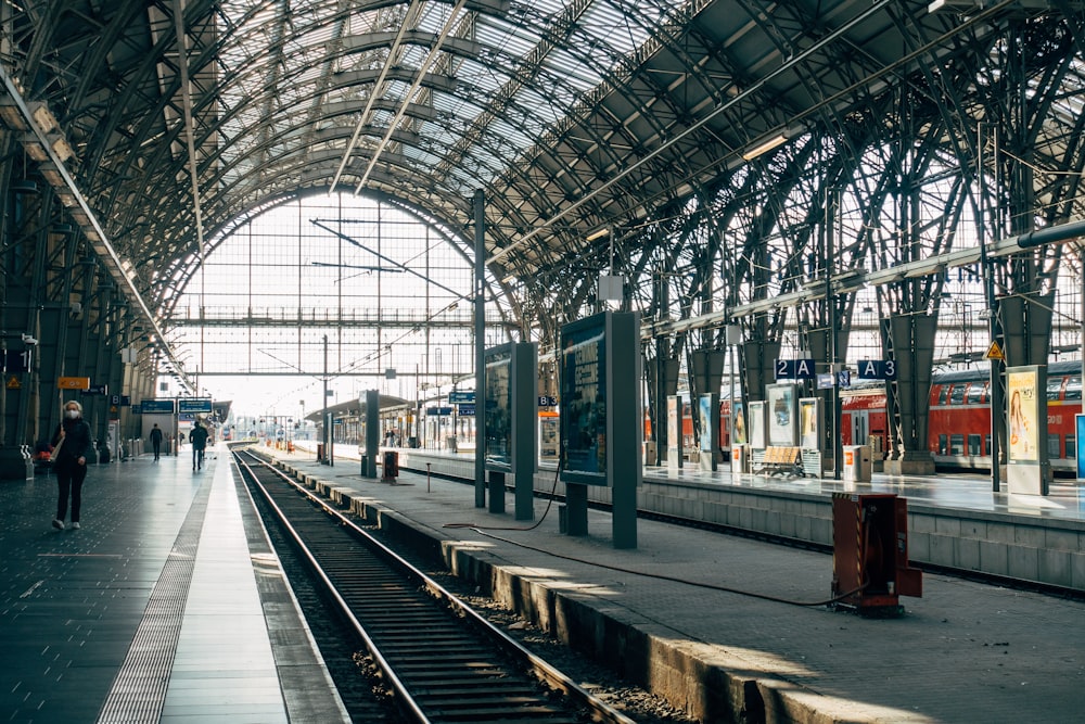 train station with people walking on sidewalk during daytime