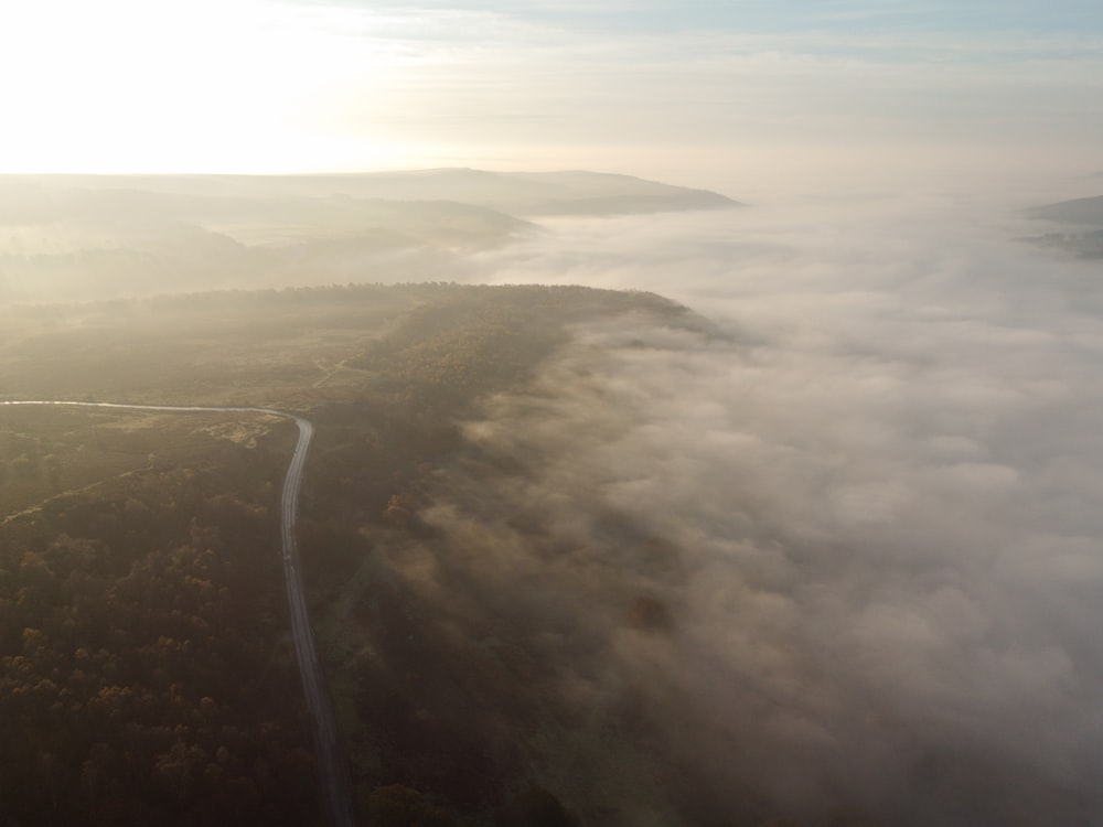 aerial view of green field under cloudy sky during daytime