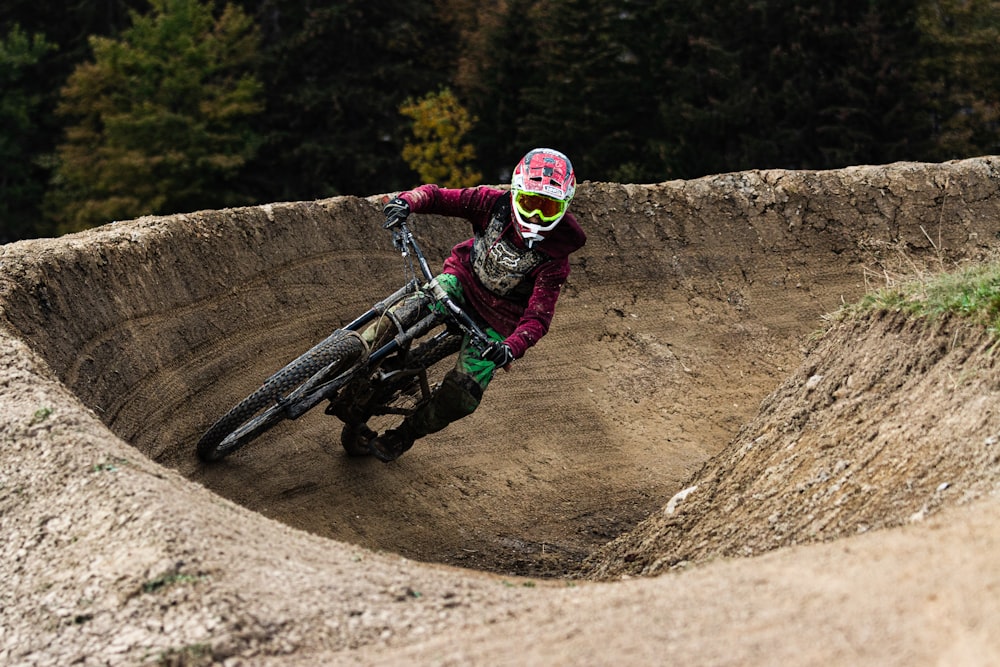 man in green jacket riding motocross dirt bike