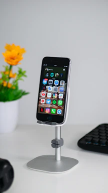 Elegant office desk with a gold pen and a smartphone showing a contact form on screen.