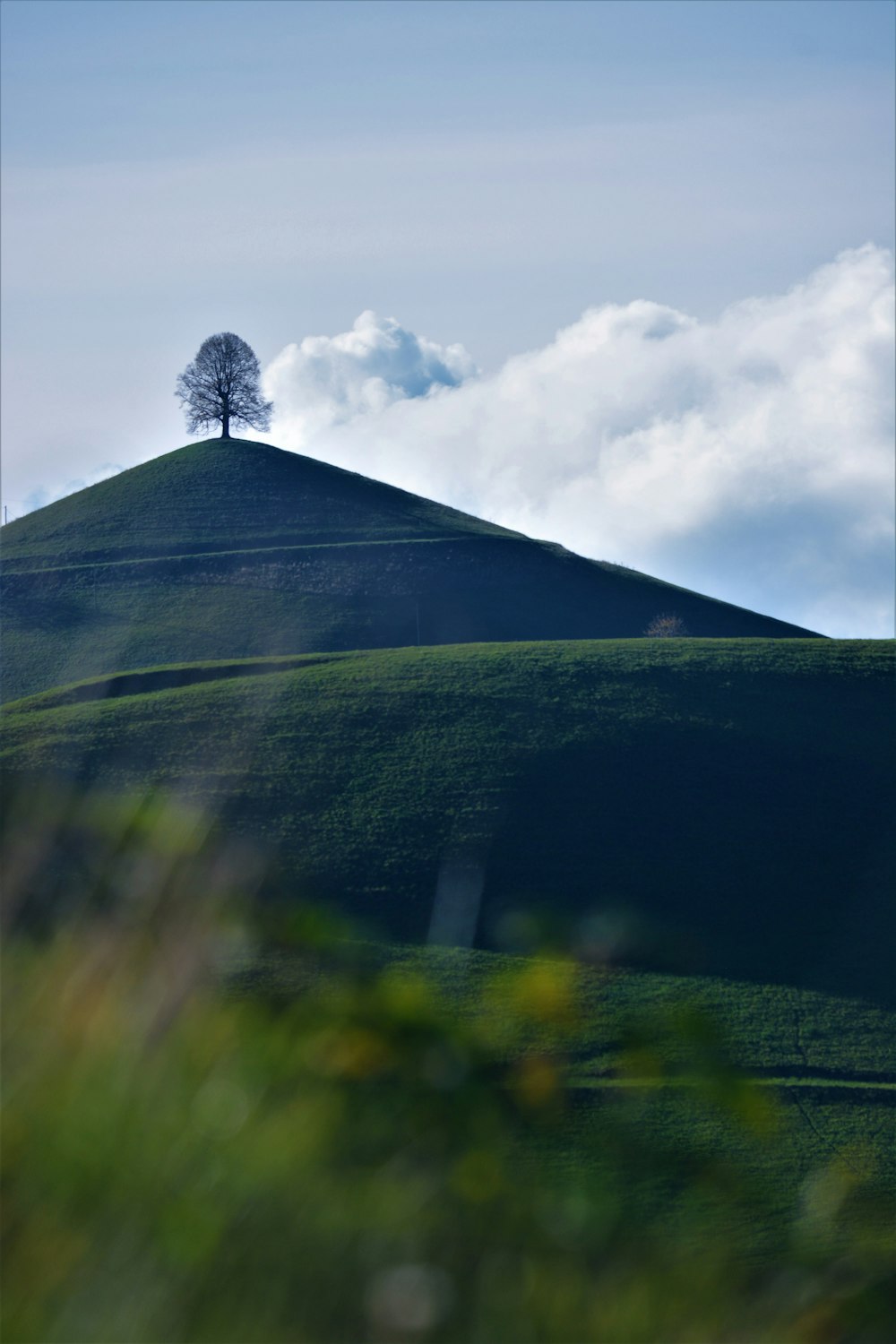 green mountain under white clouds during daytime