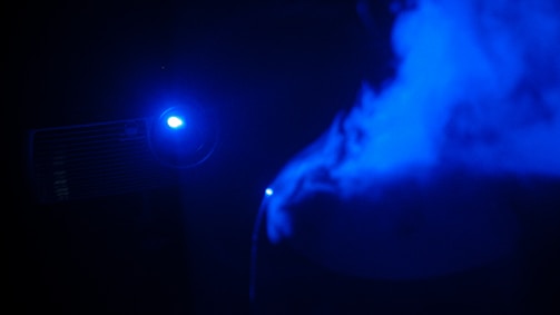 A dark studio setup with neon blue accents showcasing an animated storyboard on a large screen.