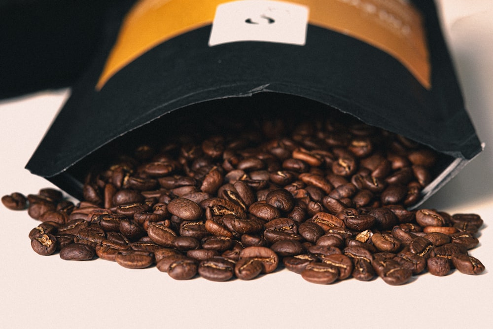 coffee beans on black ceramic bowl