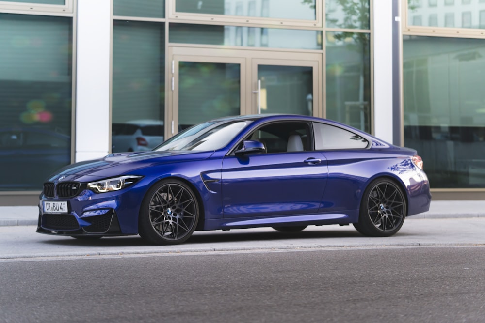 blue bmw m 3 coupe parked near building