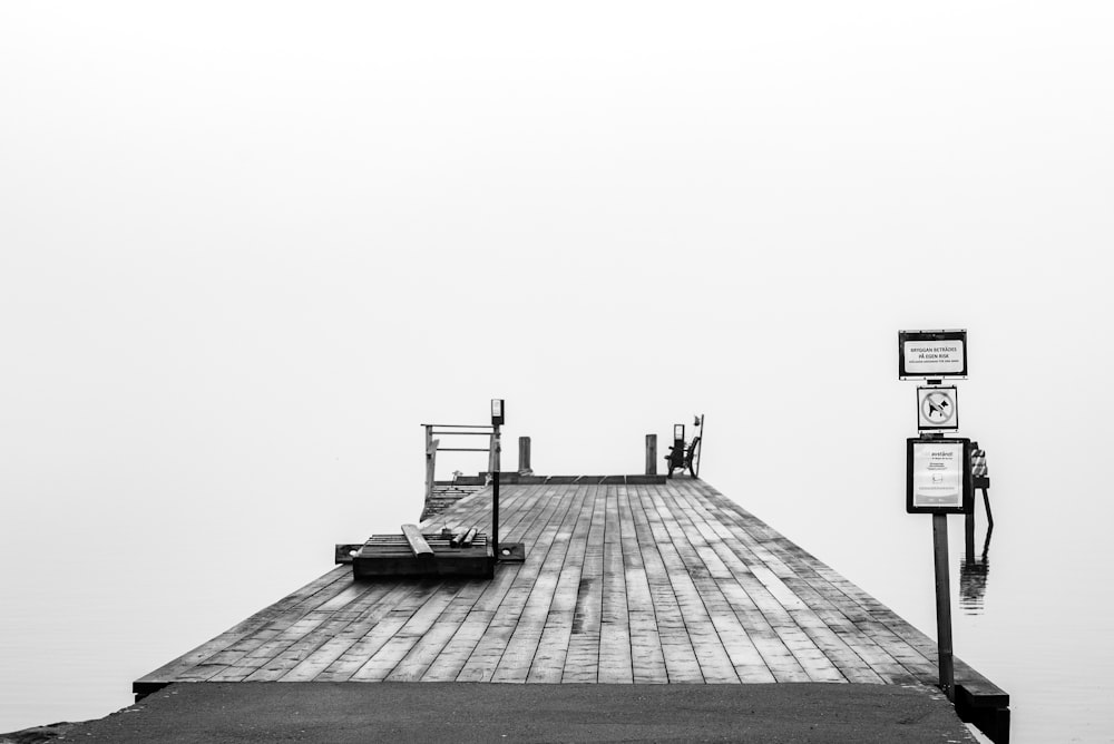 grayscale photo of wooden dock