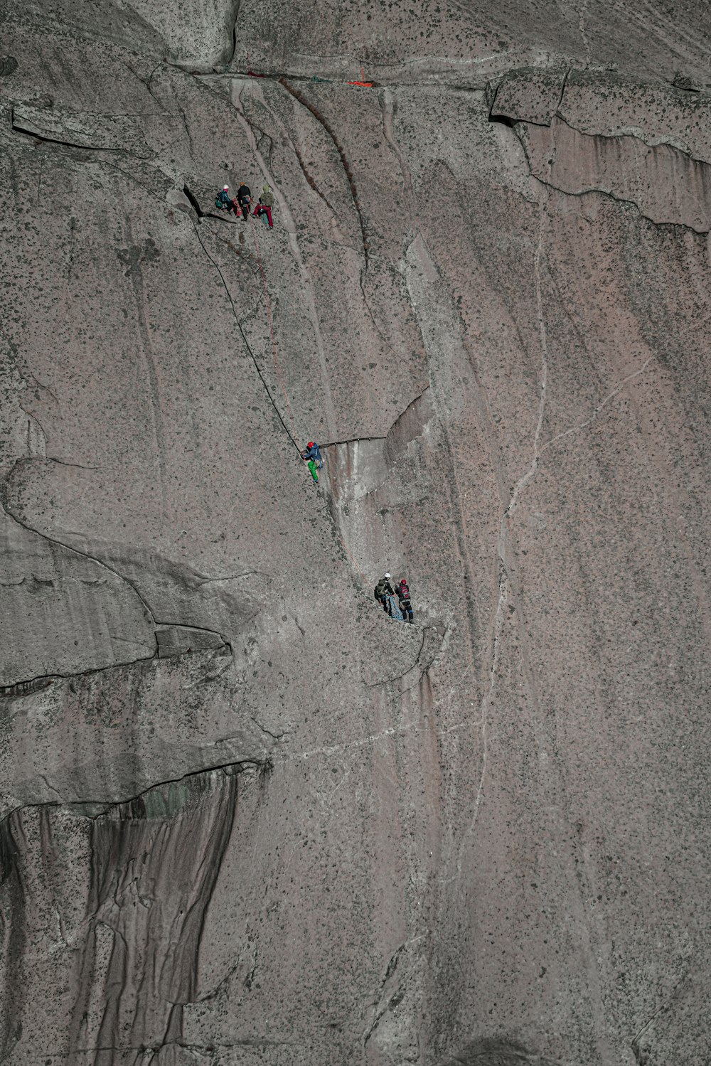 aerial view of people riding on a bicycle on a gray sand