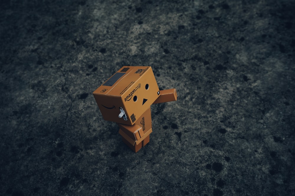 brown cardboard box on black and gray marble table