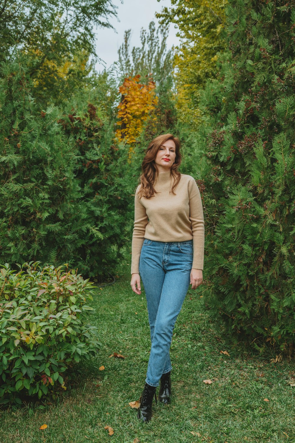 Woman in brown long sleeve shirt and blue denim jeans standing near green  plants photo – Free Russia Image on Unsplash