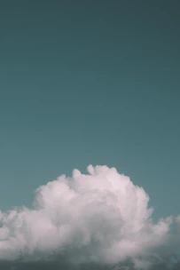 A serene cloud with digital data streams flowing into it, symbolizing cloud backup.