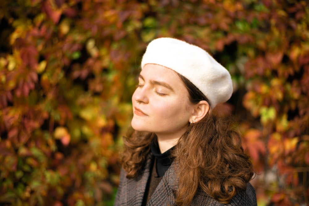 woman in white knit cap and gray scarf