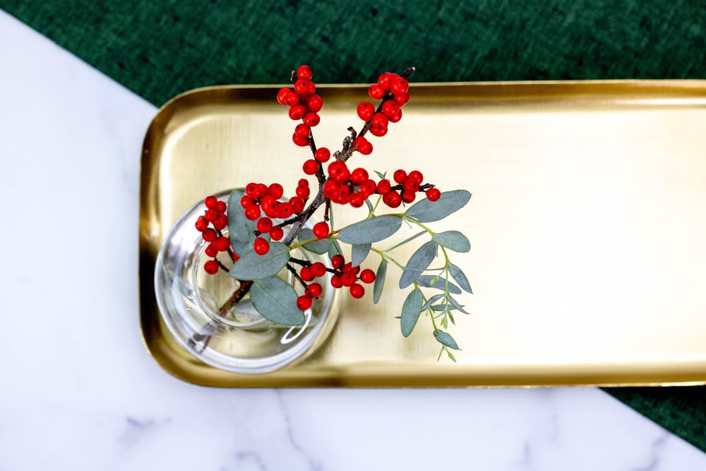 red and green flower on clear glass bowl