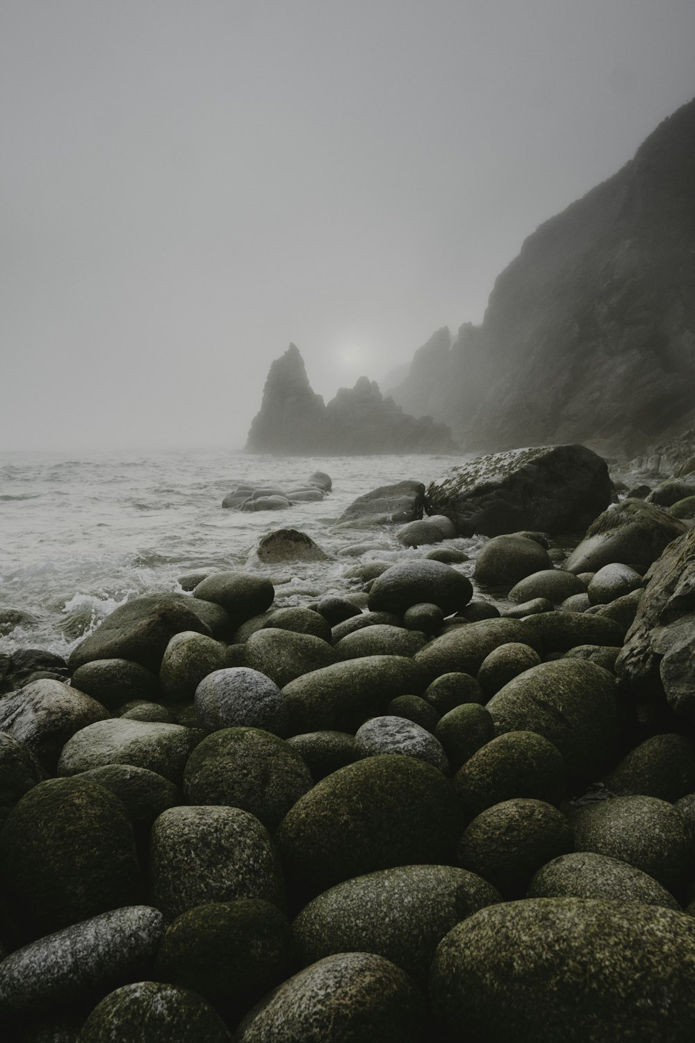 brown rocks on sea shore during daytime