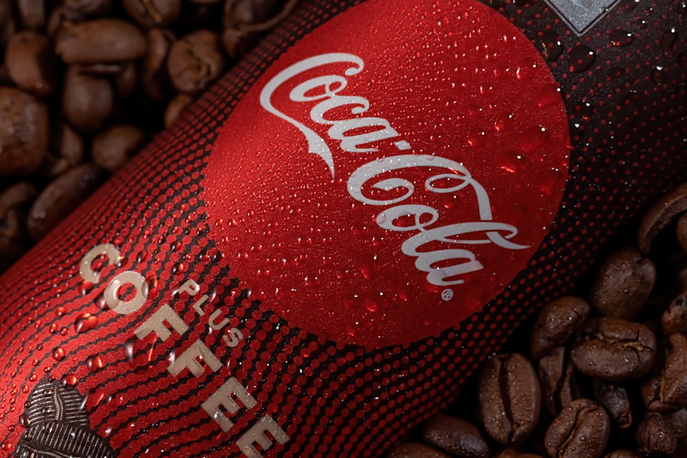 coca cola bottle on black and brown textile