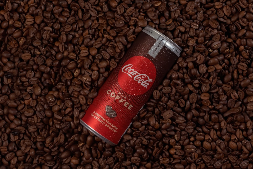 red and white can on brown coffee beans
