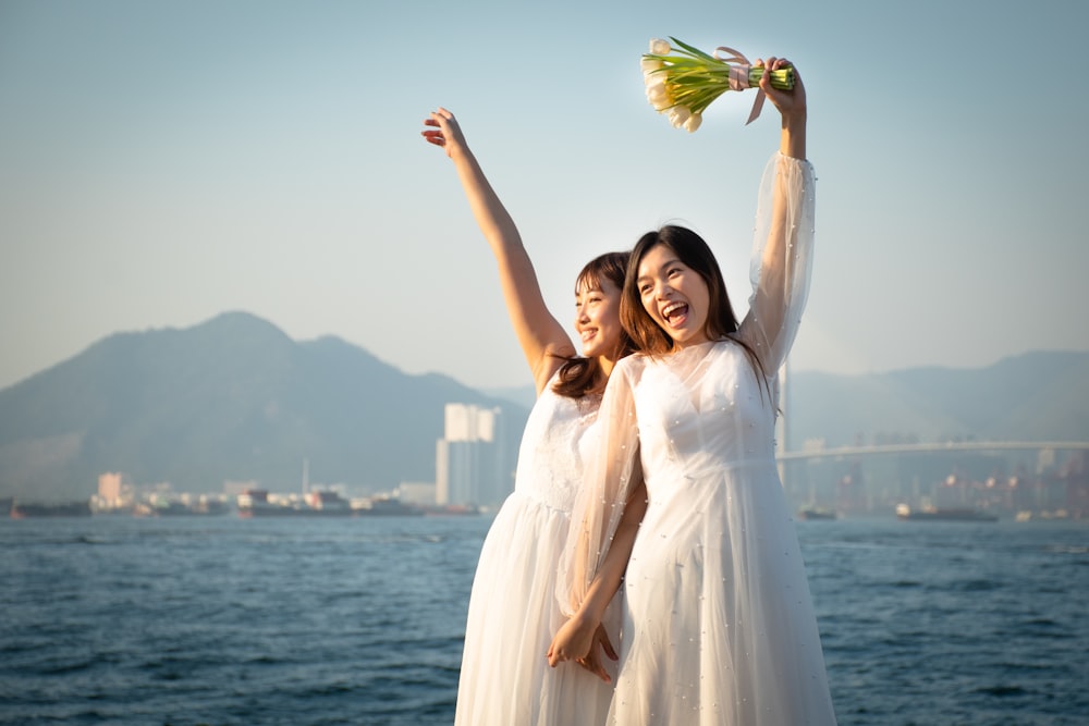 woman in white dress holding yellow and green leaf