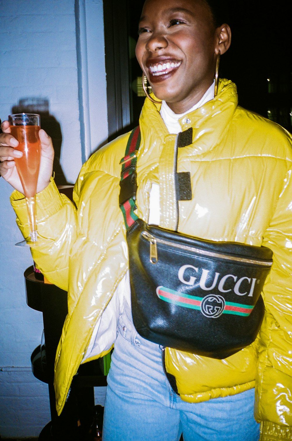 man in yellow jacket holding black leather bag