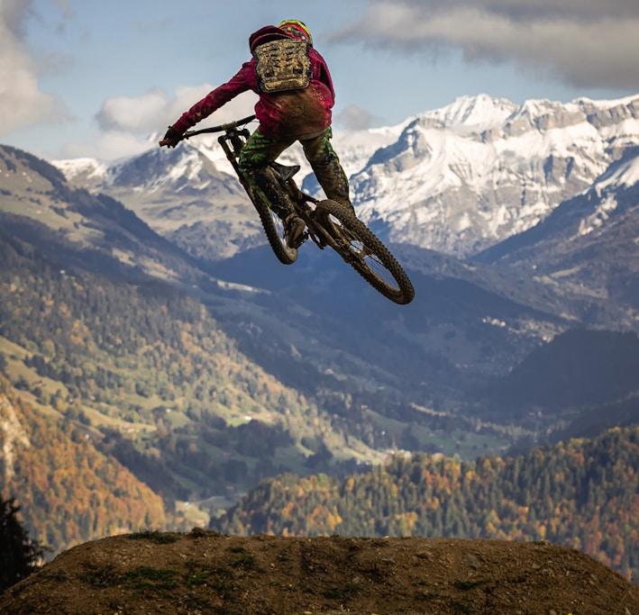 man in red jacket riding motocross dirt bike