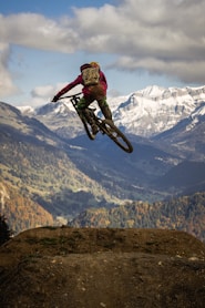 man in red jacket riding motocross dirt bike