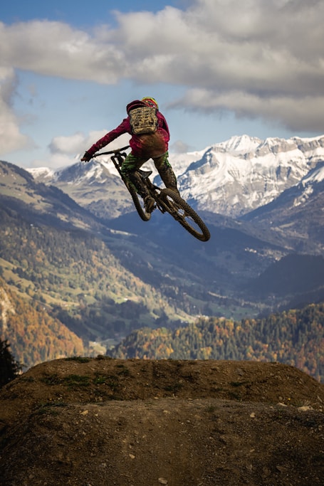 man in red jacket riding motocross dirt bike