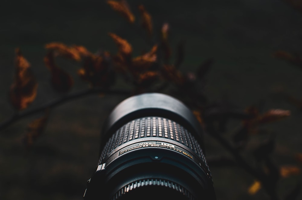 black camera lens on brown surface