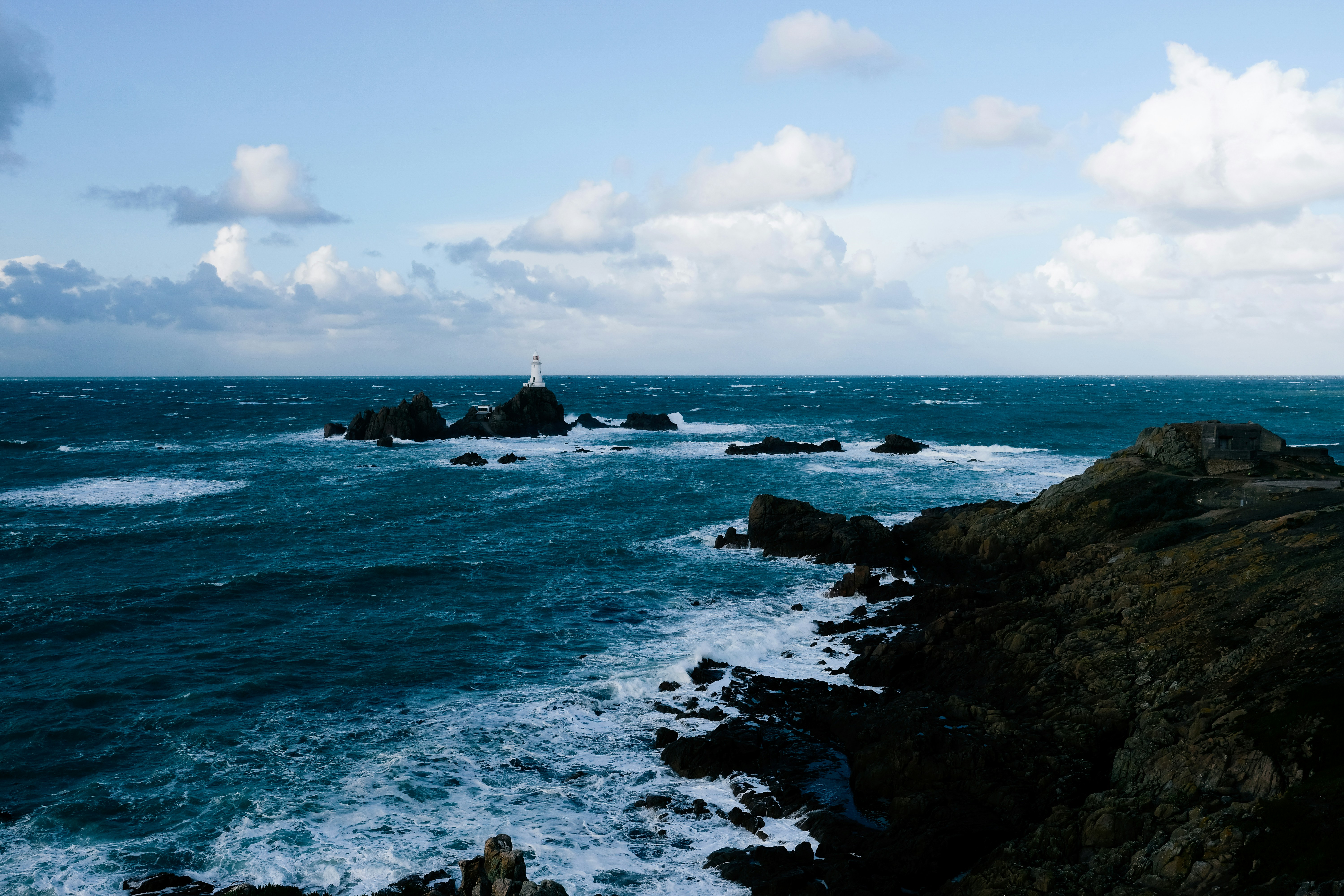 body of water near rocks during daytime