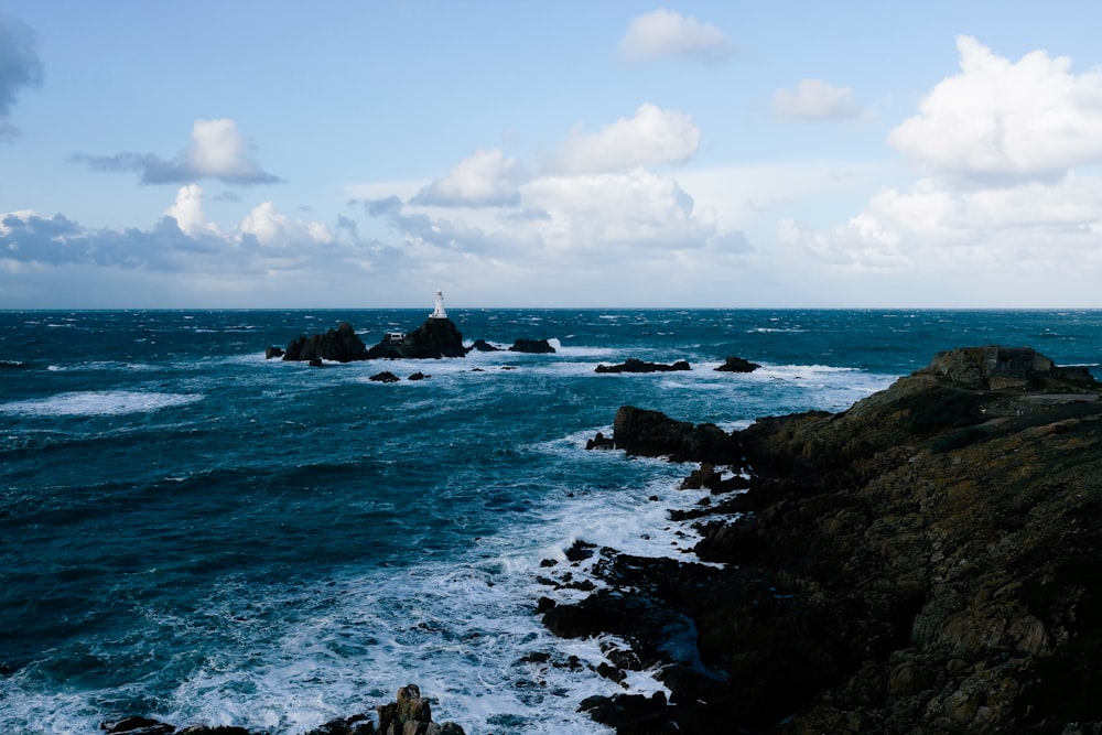 body of water near rocks during daytime