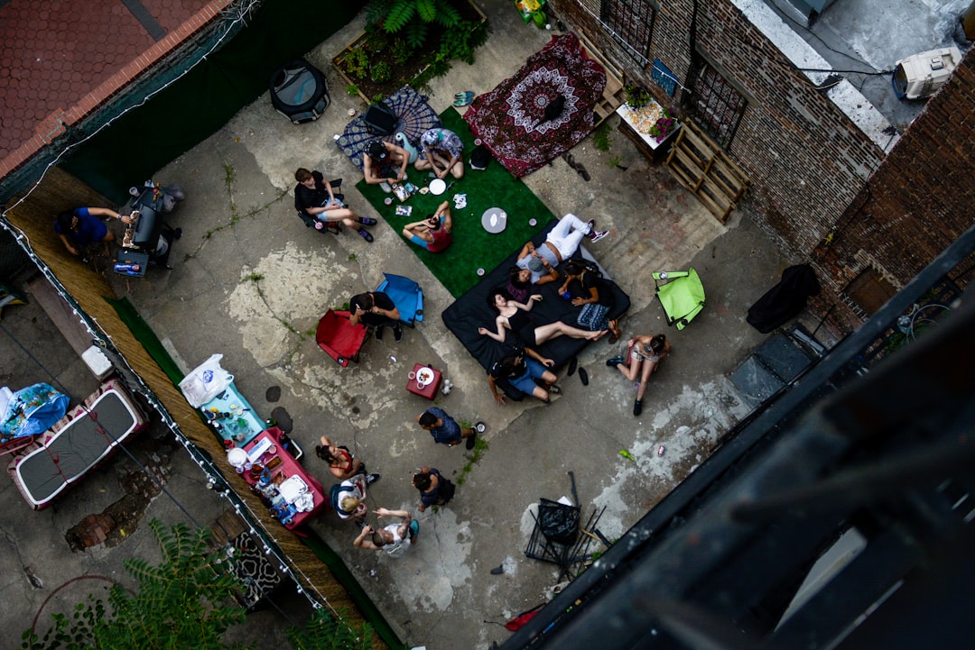 people sitting on concrete bench during daytime