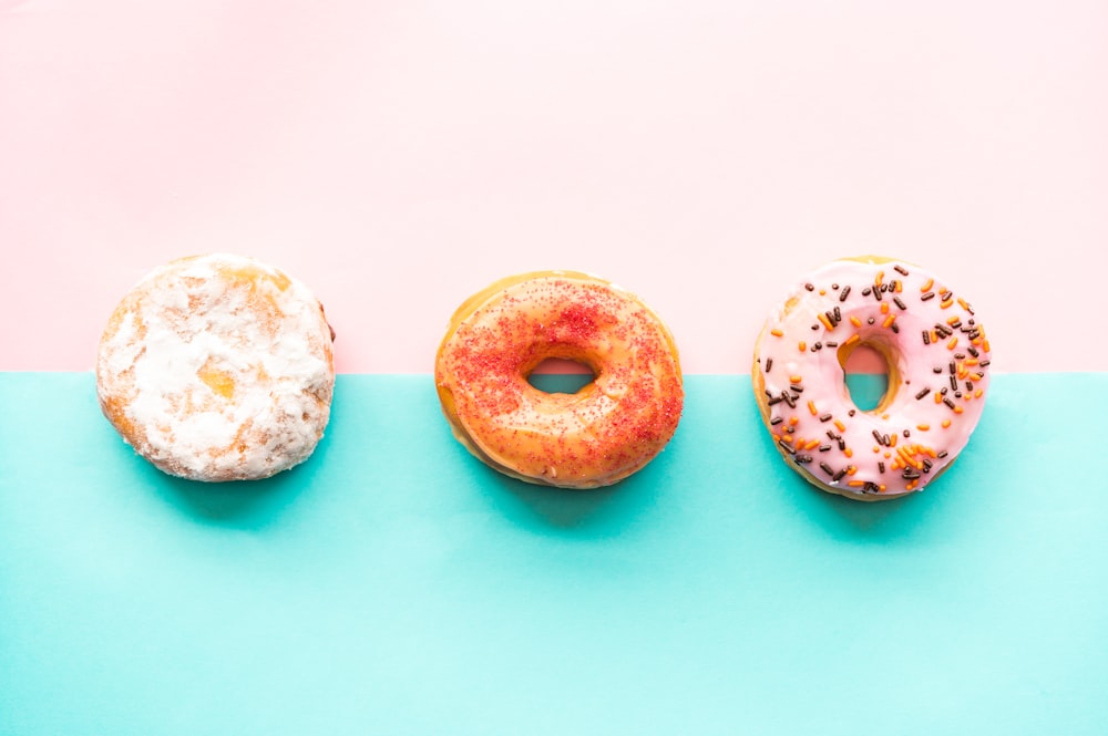 two doughnuts on blue surface