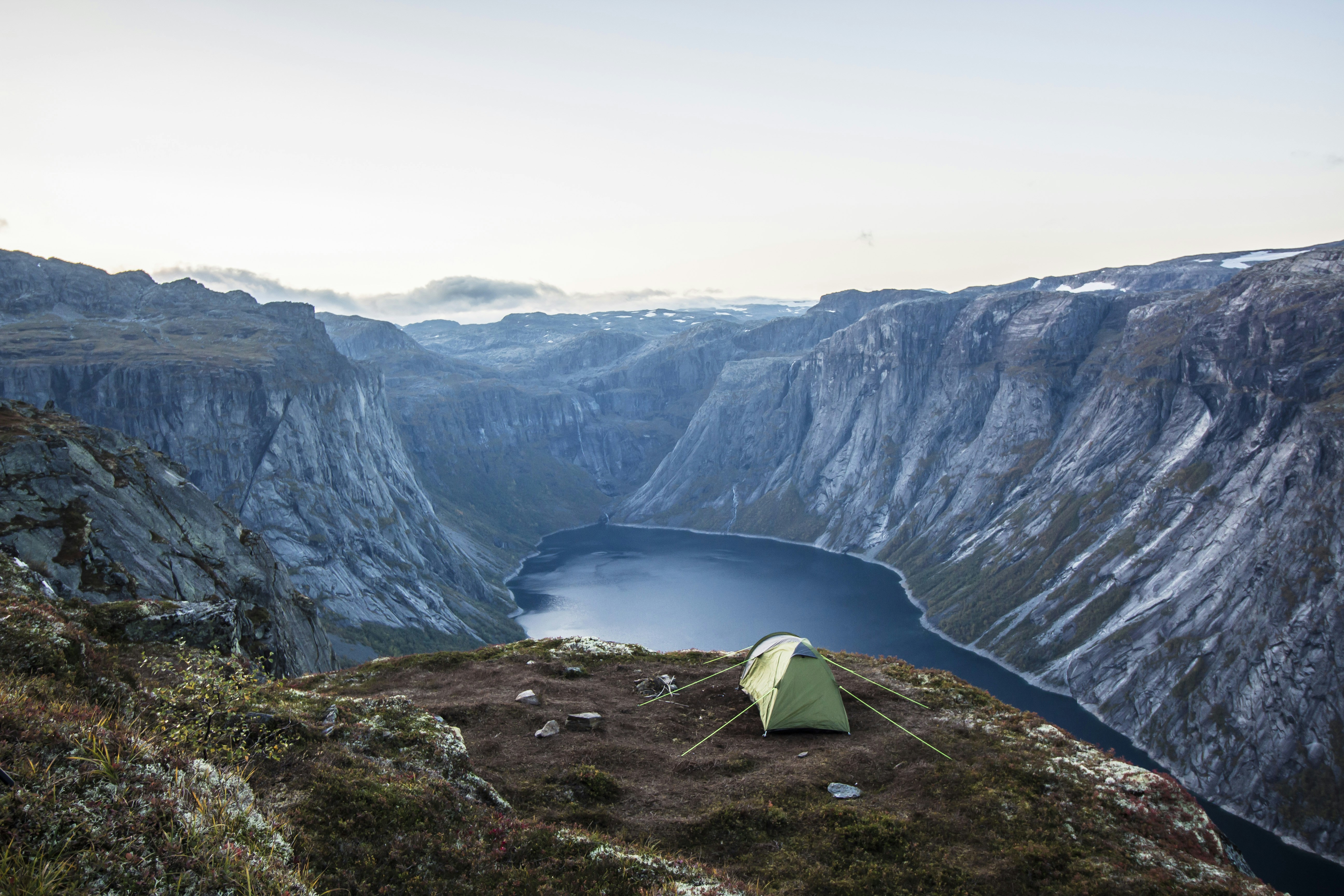 white tent on brown rocky mountain during daytime