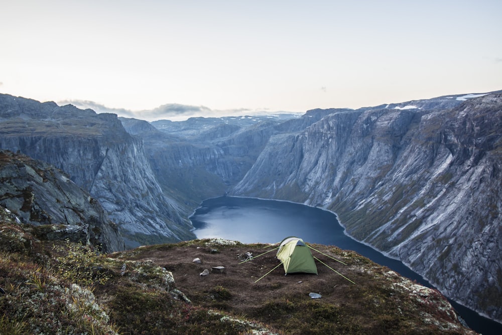 white tent on brown rocky mountain during daytime