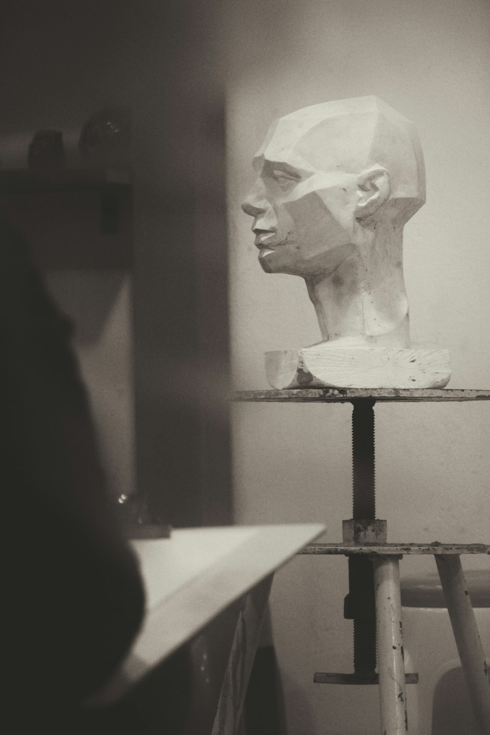 white ceramic bust on black table