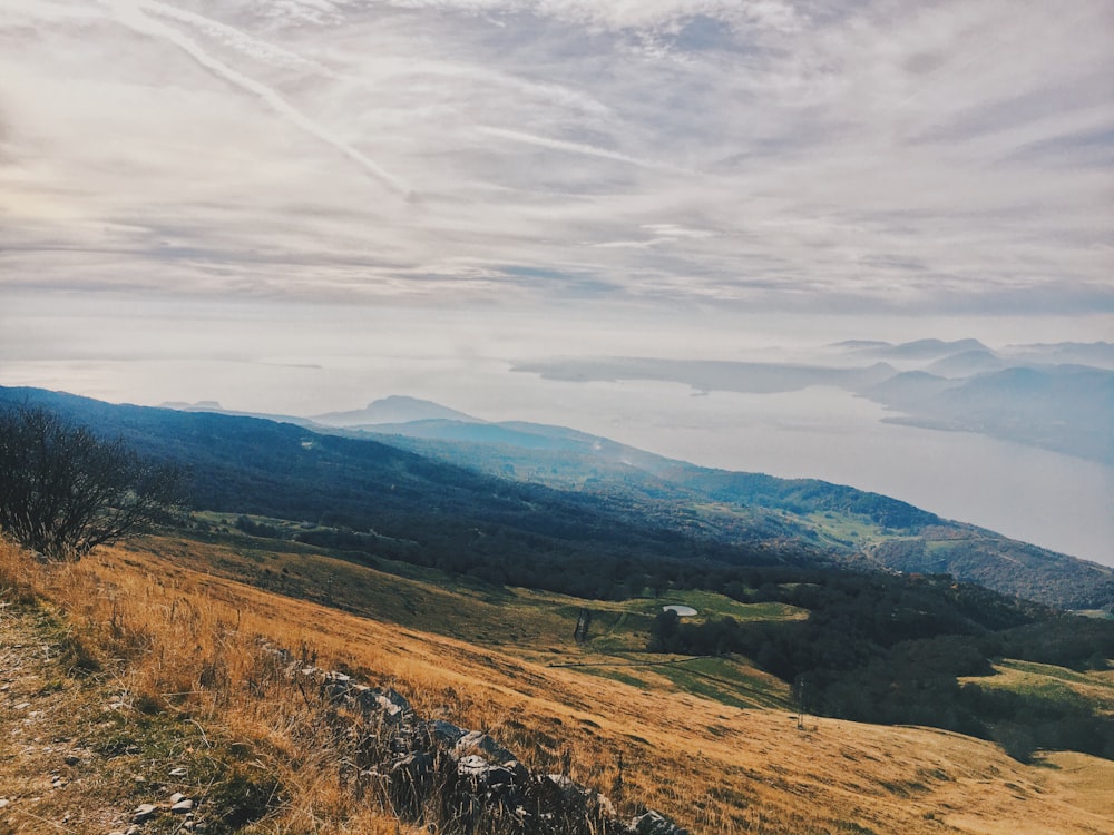 green and brown mountains under white clouds during daytime