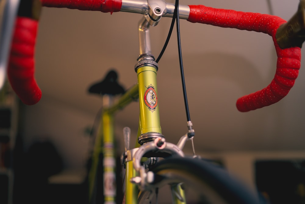 yellow and black bicycle with red handle bar