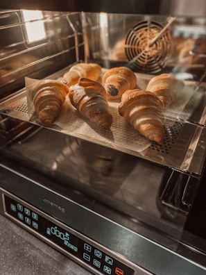 High-definition shot of automated baking machinery with golden baked goods in process.