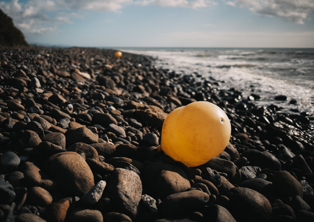 yellow and black stones on beach during daytime