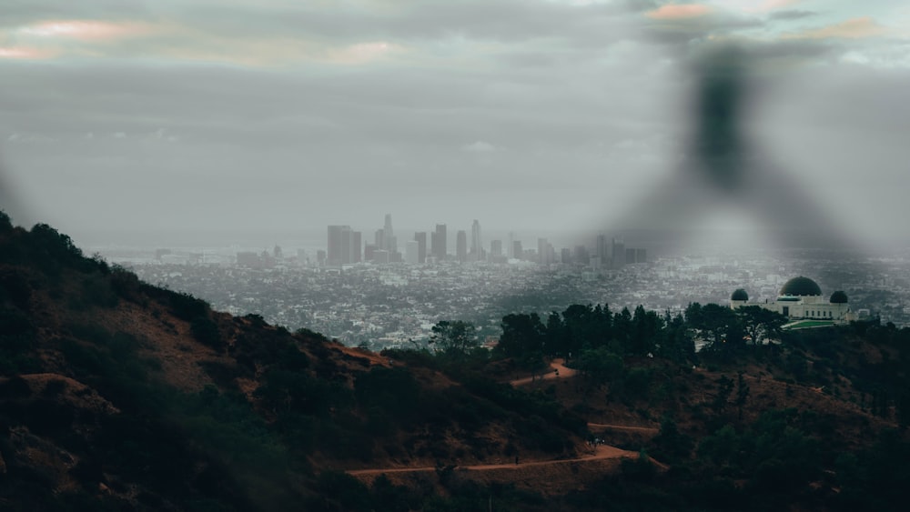 city skyline under white clouds during daytime