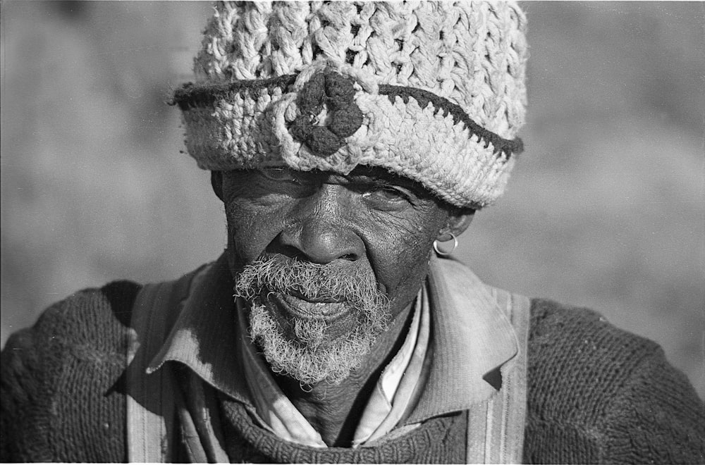 grayscale photo of man wearing knit cap