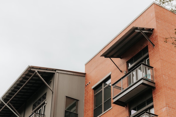 brown and white concrete building under white sky during daytime