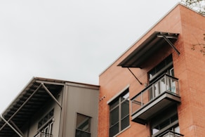 brown and white concrete building under white sky during daytime