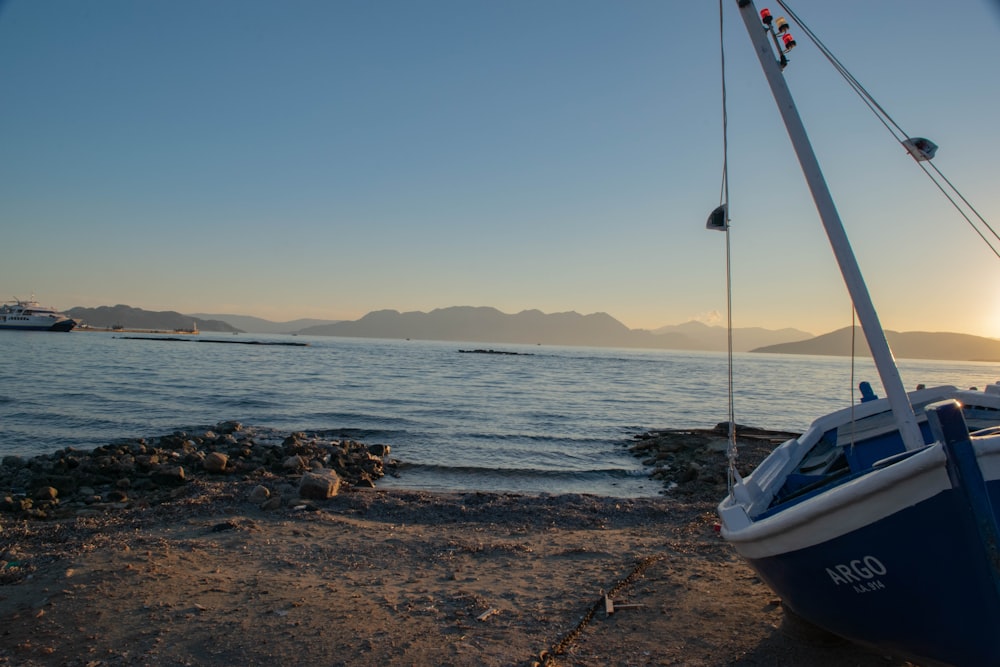 white boat on sea shore during daytime