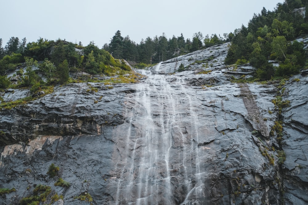 waterfalls on rocky mountain during daytime