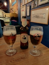 A cozy living room with a person happily opening a box of assorted craft beers from Grenoside Beer Social.