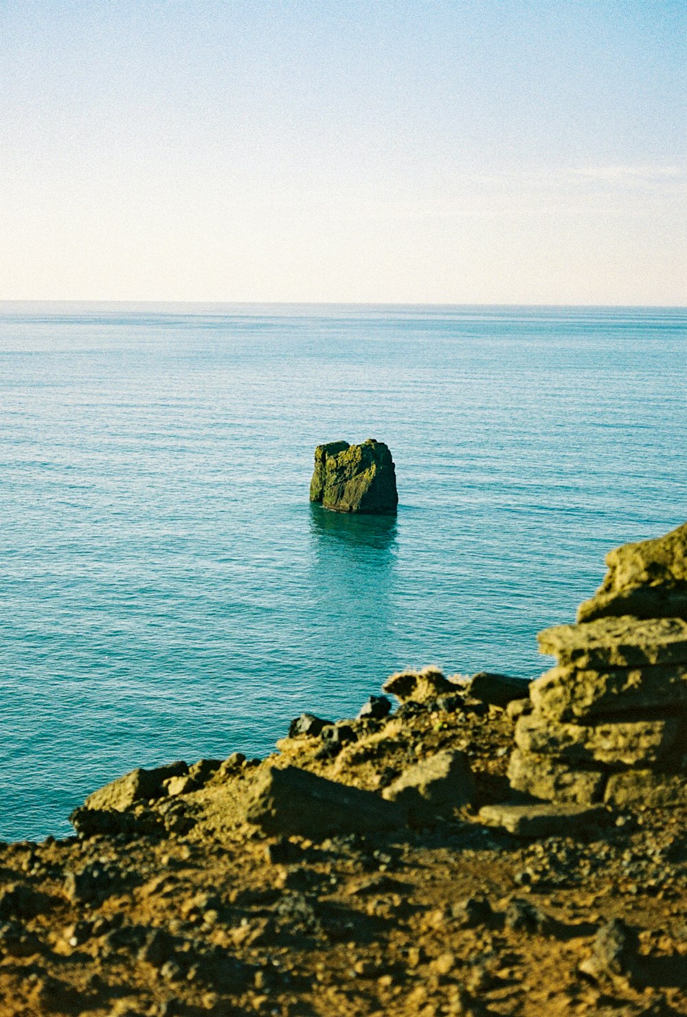 brown rock formation on sea during daytime