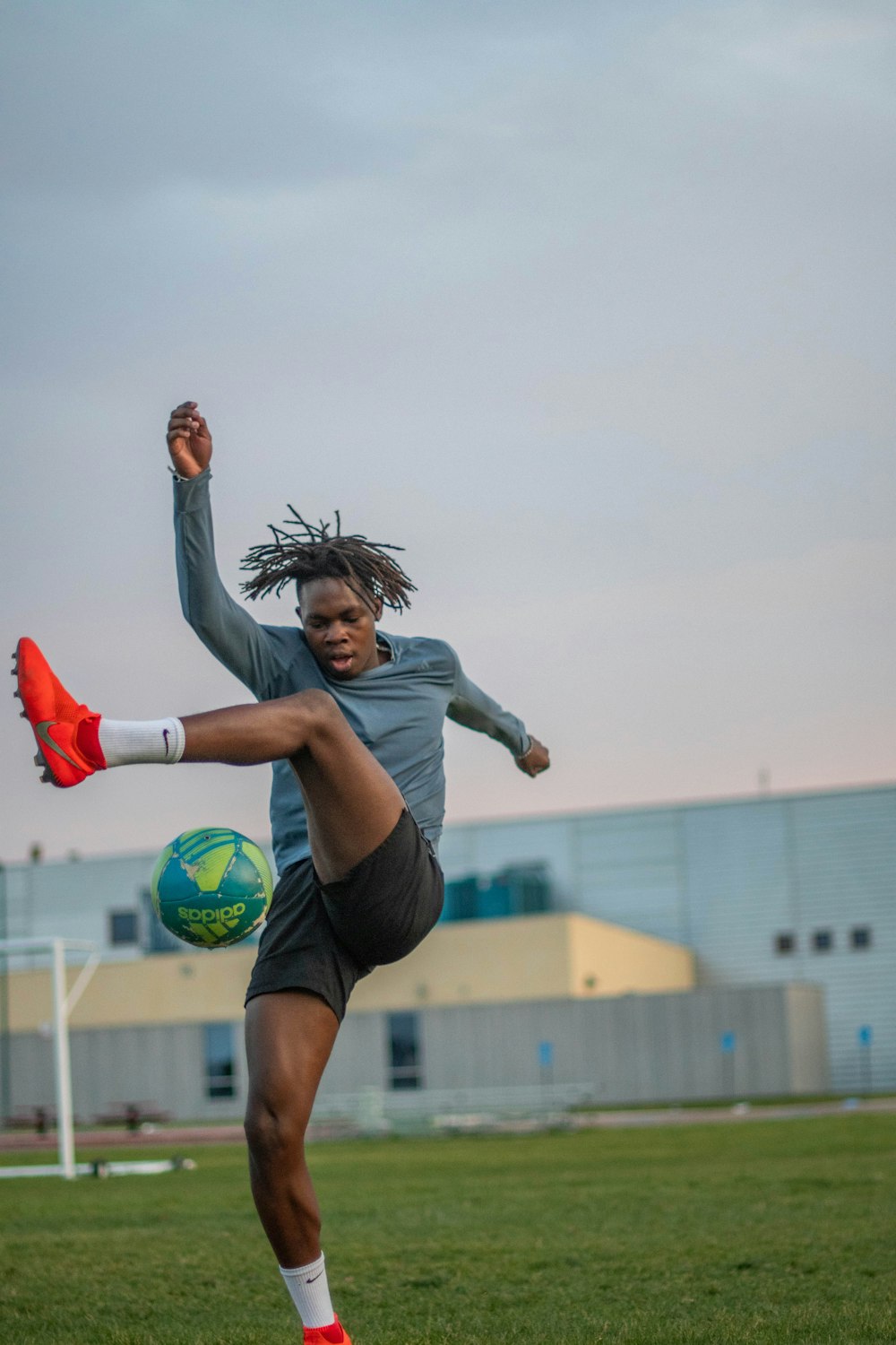 woman in black and white nike soccer jersey kicking soccer ball on green  grass field during photo – Free Image on Unsplash
